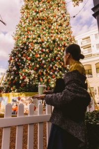 Kris Agabaian with a cup of coffee and the xmas tree