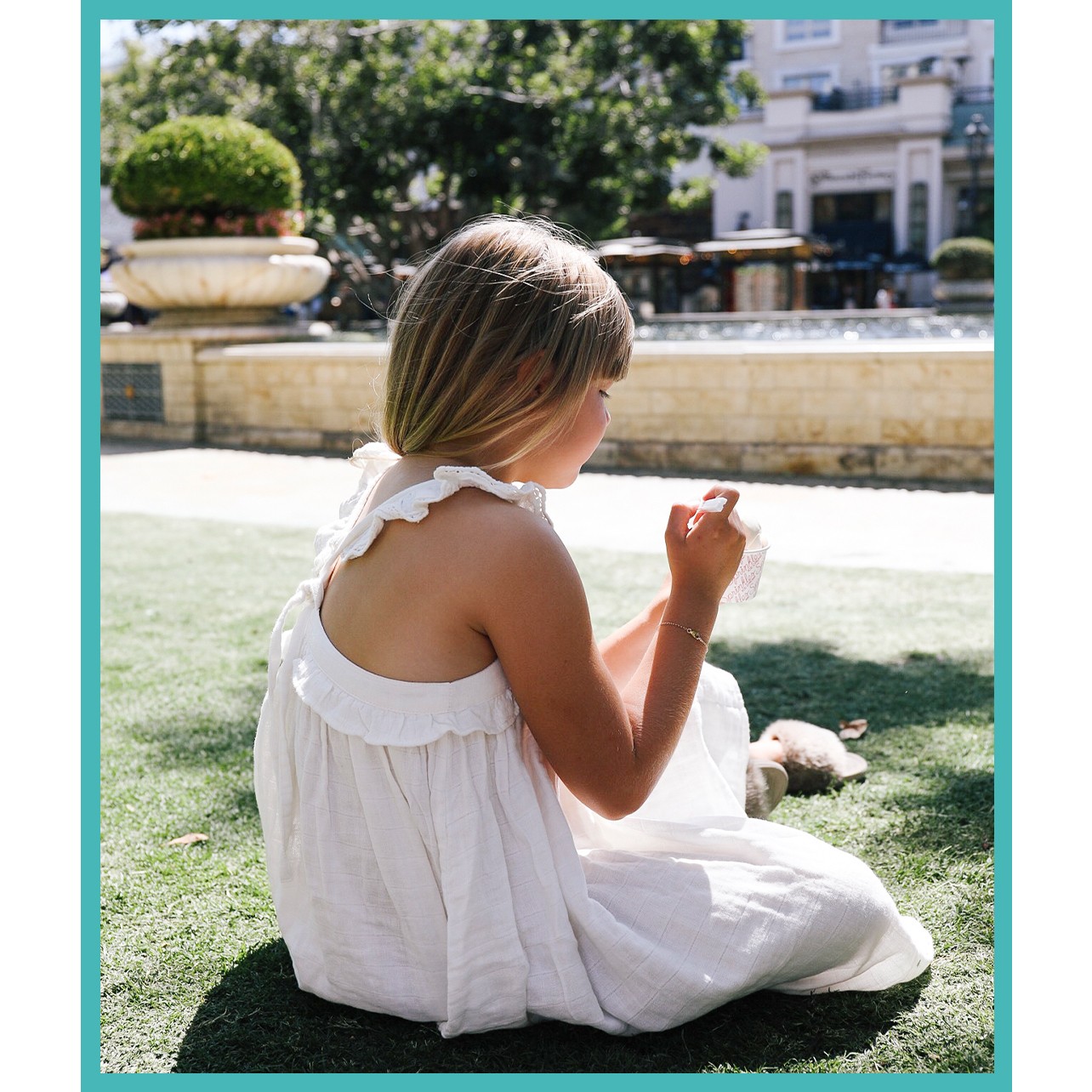 Picture of a girl in a white dress eating an ice cream